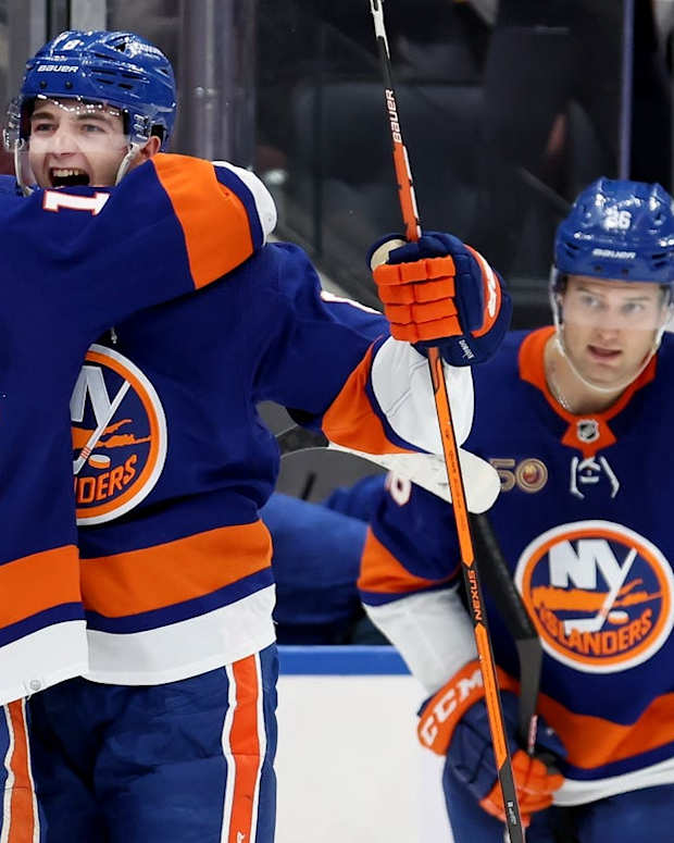 Nov 7, 2022; Elmont, New York, USA; New York Islanders defenseman Noah Dobson (8) celebrates with center Mathew Barzal (13) after scoring the game winning overtime goal against the Calgary Flames at UBS Arena. Mandatory Credit: Brad Penner-USA TODAY Sports